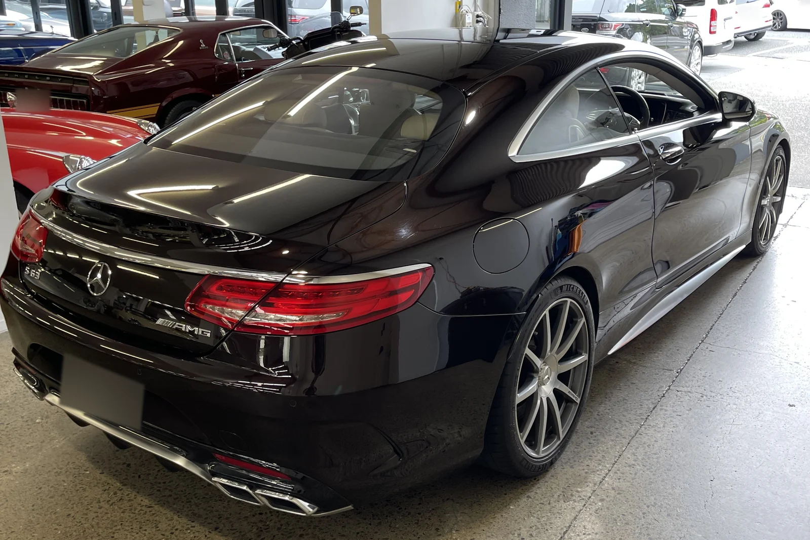 Black Mercedes-AMG coupe showing its reflective paintwork